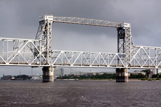 A big metal modern bridge on a river
