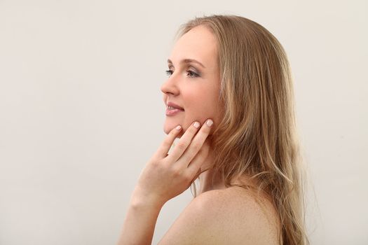 Young natural woman with clear face isolated over white background