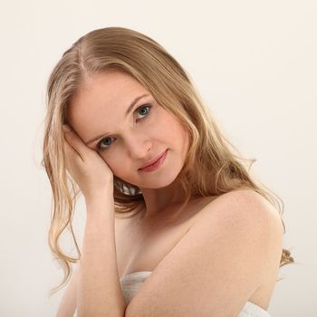 Young natural woman with clear face isolated over white background