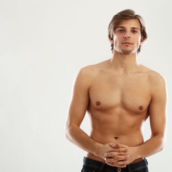 Young beautiful man with naked torso isolated over white background