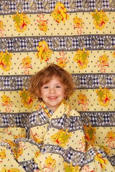 Little girl in colorful linen studio shot