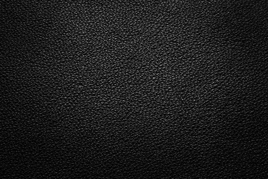 Black leather texture for background with light from above
