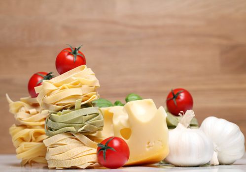 Fresh ingredients for pasta isolated on wooden background