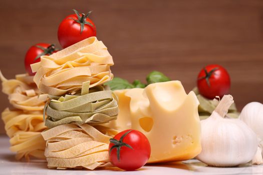 Fresh ingredients for pasta isolated on wooden background