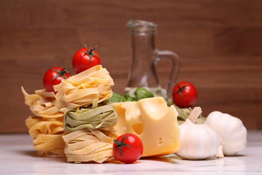 Fresh ingredients for pasta isolated on wooden background