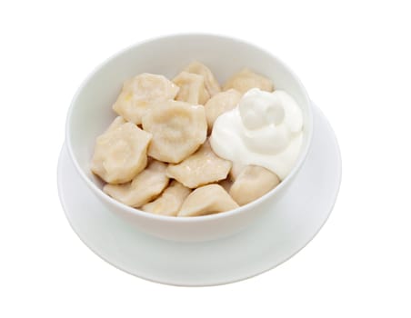Traditional Russian food "pelmeni".Meat dumplings  with sour cream