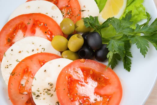 Arrangement of mozzarella and tomatoes.Italian kitchen.