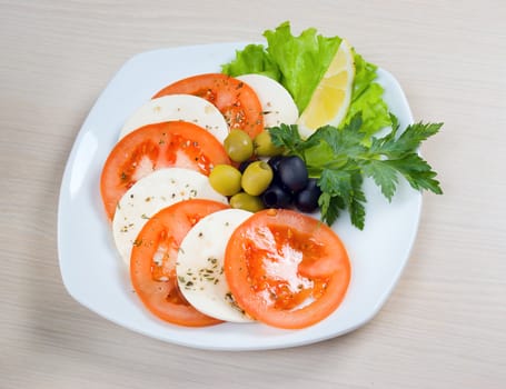 Arrangement of mozzarella and tomatoes.Italian kitchen.