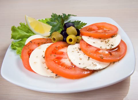 Arrangement of mozzarella and tomatoes.Italian kitchen.