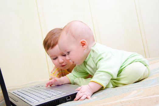 Little girl and boy using laptops.Computer generation