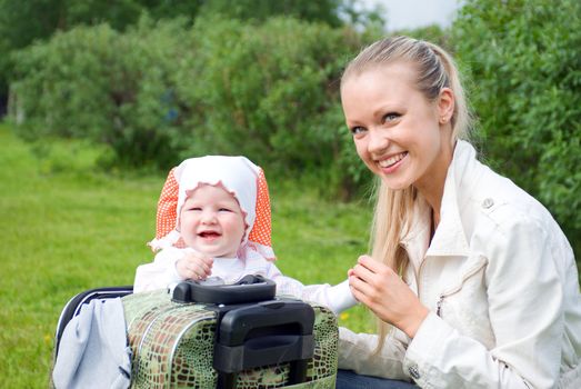 younger woman and child in valise.family goes to journey