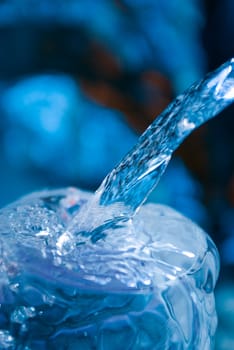 Water being poured into a glass.Glasses with creative splashing water