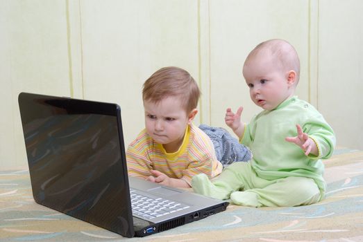 Little girl and boy using laptops.viewing the baby film