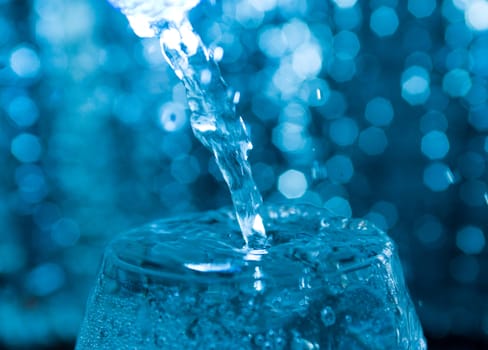 Water being poured into a glass.Glasses with creative splashing water
