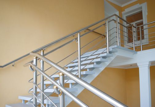 stairway enclosure with metallic stair railing within building