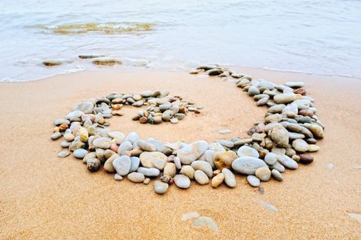 Spiral of the pebble on the sea sand