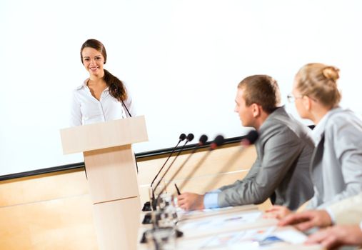 businessmen communicate at the conference, sitting at the table, on the table microphones and documents