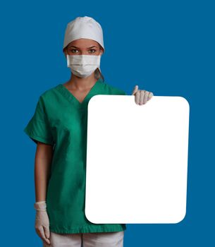 A young woman doctor holding an empty white bill board against a blue background.