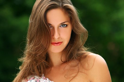 Portrait of young beautiful caucasian woman enjoy summer in a park