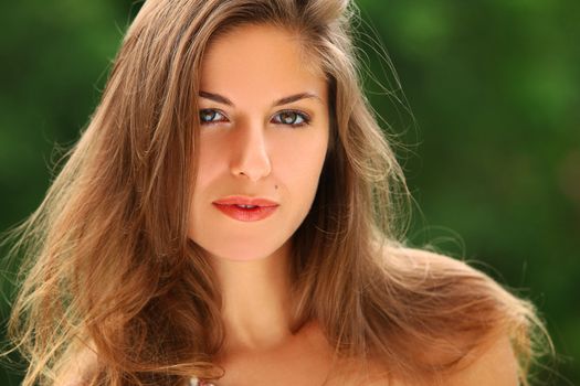 Portrait of young beautiful caucasian woman enjoy summer in a park