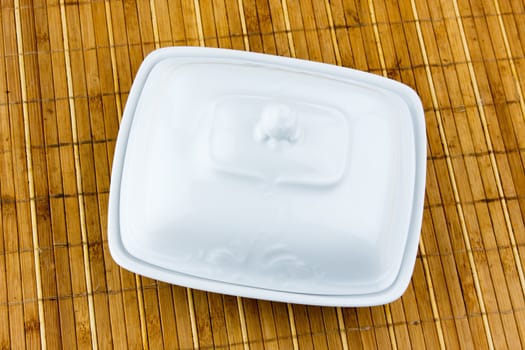 oval dish for butter on a bamboo napkin