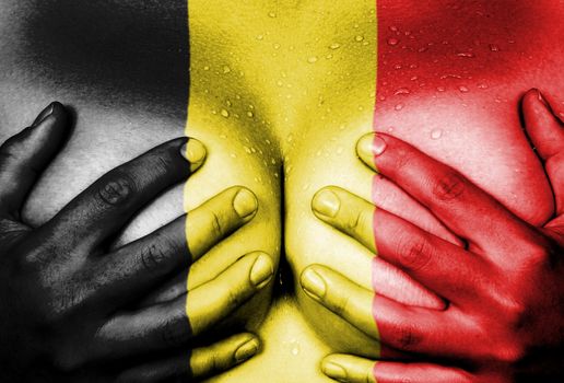 Sweaty upper part of female body, hands covering breasts, flag of Belgium