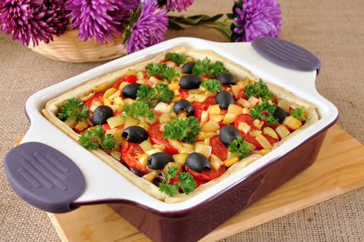 Vegetable tart with olives in a cauldron