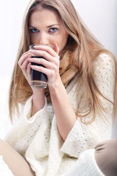 Long-haired young blonde woman with a cup of coffee