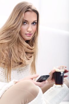 Long-haired young blonde woman with a cup of coffee and telephone







background beige blond blue coffe cold cup drink eyes glass hair hands long scarf sweater telephone white woman worm