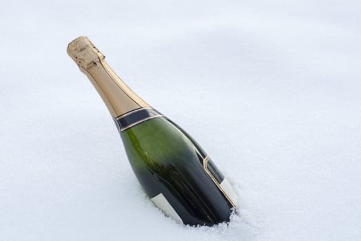 full bottle champagne in the winter snow