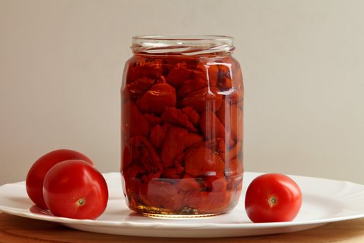 canned tomato  with three  tomatoes