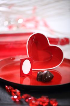 Red glass heart on a plate. Photo Frame inside heart