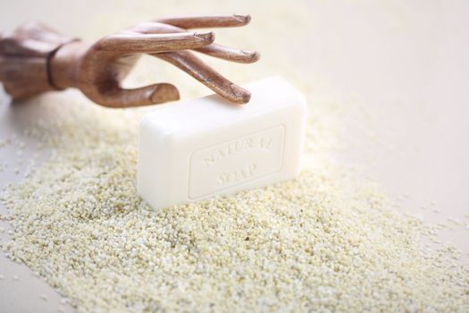 Wooden brown hand on piece of white soap.