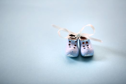 Small shoes on the blue background