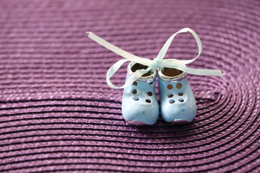 Small shoes on the violet background