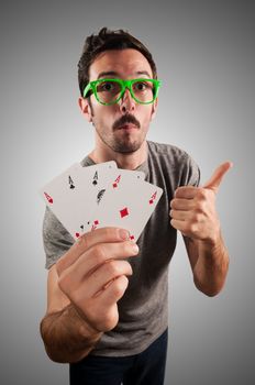 winner guy holding poker cards on grey background