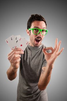 winner guy holding poker cards on grey background