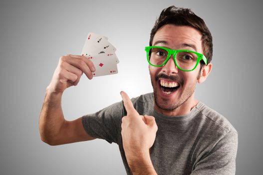 winner guy holding poker cards on grey background