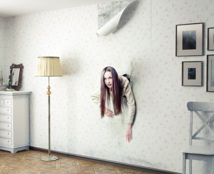 woman climbs through the wall into the room