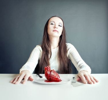 beautiful woman and human heart on the plate (concept)