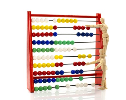 two wooden puppet in teamwork on the abacus