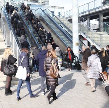 People on the elevator enter Macef, International Home Show Exhibition dedicated to interior design, home luxury and furniture innovation in Milan, Italy.