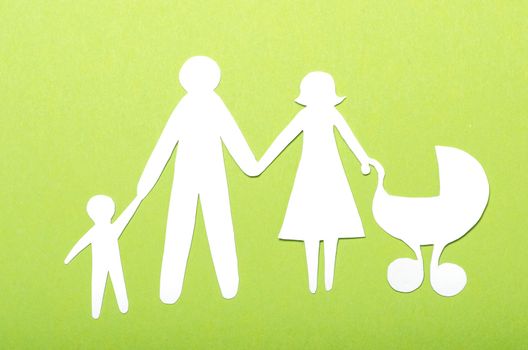 Closeup of paper family on green background
