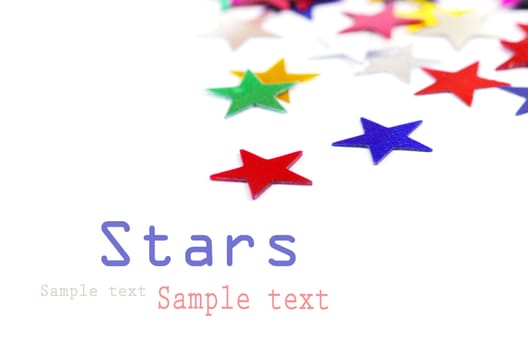 Christmas decoration of colored confetti stars against white background