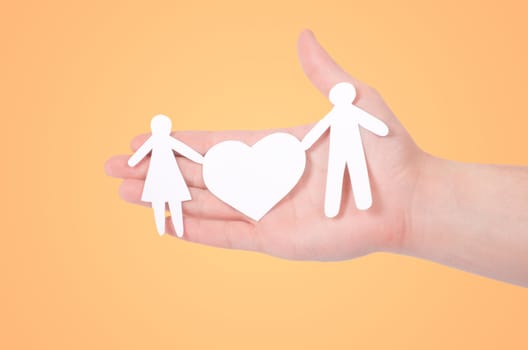 paper family in hands isolated on white