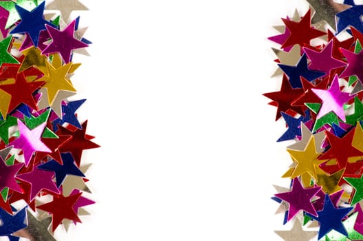 Christmas decoration of colored confetti stars against white background
