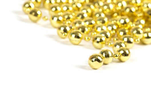 Background made of a brilliant celebratory beads of golden color over white