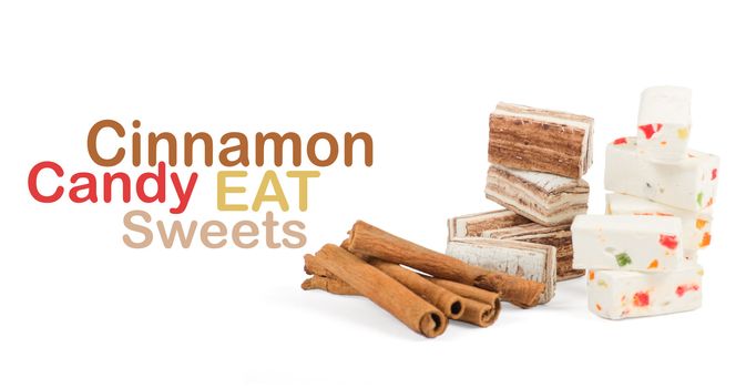 Sweets and cinnamon sticks isolated on white background