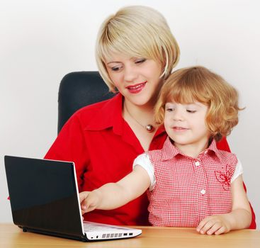 Mother and little daughter with laptop