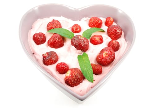 Strawberries with cream in heart shape plate
